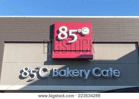 RICHARDSON, TX, USA-JAN 20, 2018:Close-up logo exterior of 85 C Bakery Cafe again blue sky. A Taiwanese chain of coffee shops and self-serve bakeries operated by Gourmet Master Co., Ltd