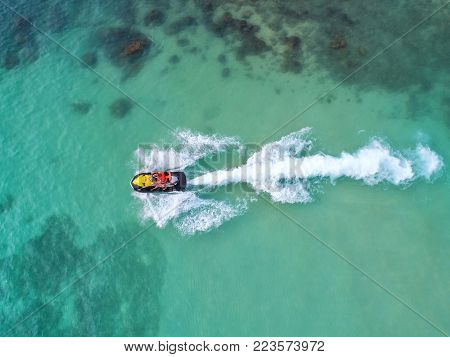 People are playing a jet ski in the sea.Aerial view. Top view.amazing nature background.The color of the water and beautifully bright. Fresh freedom. Adventure day.clear turquoise at tropical beach.