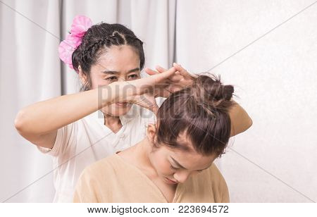 Woman is getting massaged on the back of the head