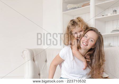 Mother and daughter enjoy at home and looking at the camera