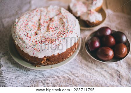 Easter Table With Traditional Easter Cakes And Easter Eggs With Blossoming Tree Branch