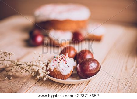 Easter Table With Traditional Easter Cakes And Easter Eggs With Blossoming Tree Branch