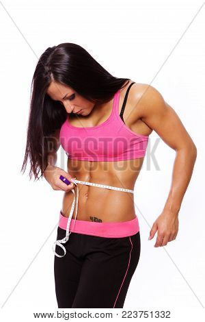 Portrait of sexy woman with ruller posing in studio