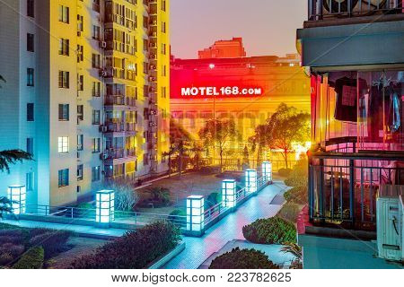 SHANGHAI, CHINA - FEBRUARY 05: Night view of high rise apartments with a view the a Motel 168 motel in the distance on February 05, 2016 in Shanghai