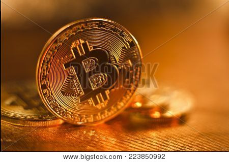 Bitcoin. several coins of bitcoin on a golden background
