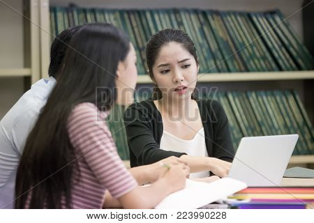 Group Of Student Seaching Information In The Library Together. People With Education Concept.