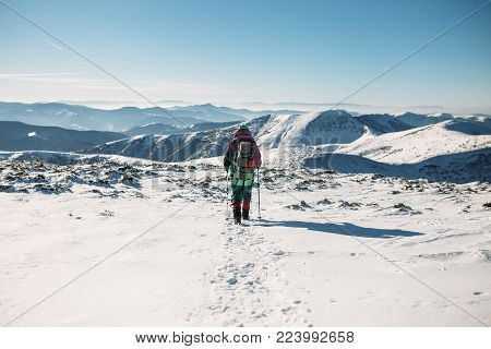 Climber Walking Downhill In Winter, Carpathian Mountains At The Winter, Snow Day