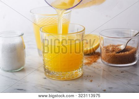 Homemade Isotonic Energy Drink And Ingredients. Glasses With Yellow Liquid, Homemade Sport Beverage,