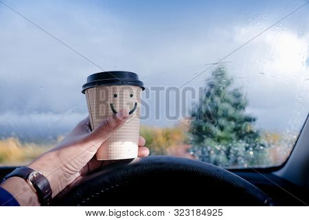 Happy And Positive Mind Concept. Driver Holding A Coffee Mug With Smiling Face Cartoon, Blurred Rain