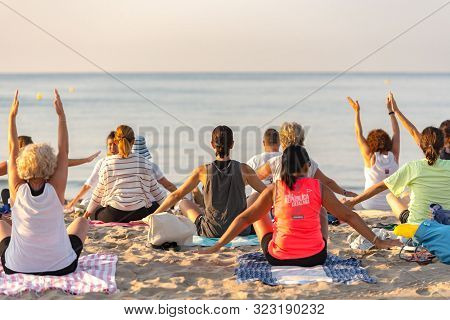Altafulla, Tarragona, Spain : 219 August 31 :  Yoga Instructor Leading A Group Session At Sunset On 