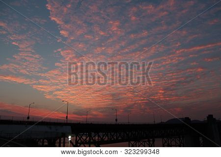 vibrant clouds during golden hour by a bridge near the Golden Gate in San Francisco CA