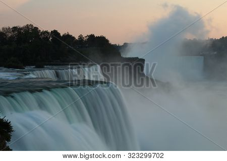 Close up of Niagara Falls in evening as seen from USA, with water flow all blurred