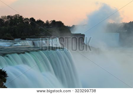 Close up of Niagara Falls in evening as seen from USA, with water flow all blurred