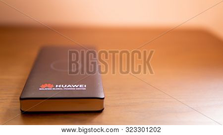 Sungai Buloh, Malaysia - July 19, 2019: Huawei Wireless Portable Power Bank On A Brown Wooden Table.