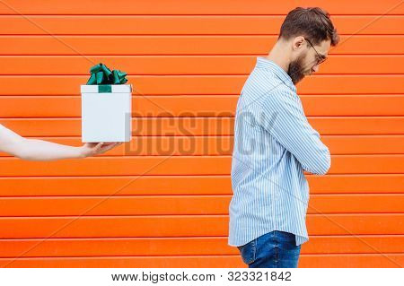 Hand Of Unrecognizable Person Holding And Giving Gift Box With Green Bow For Beard Hipster Man Isola