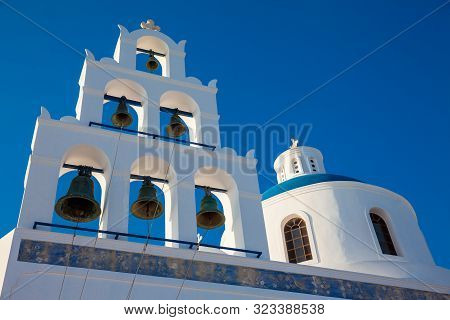 Dome And Bell Tower Of The Church Of Panagia Platsani Located In Oia City At Santorini Island In A B
