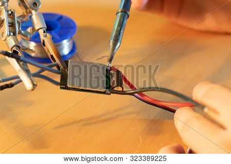 Electronic Device Repaired With A Soldering Iron.