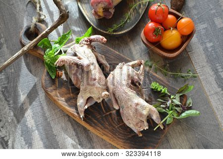 Raw Woodcock With Vegetables And Greenery On Rustic Wooden Table