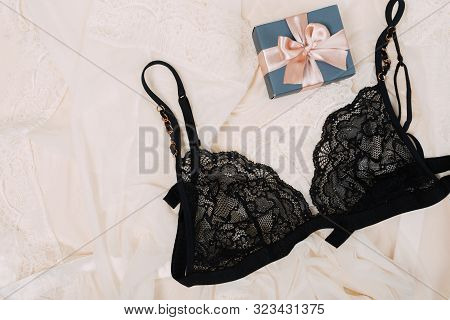 Black Women Underwear With Lace And Gift Box On Beige Background. White Bra And Pantie.copy Space. B
