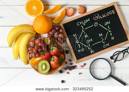 Glucose Molecule On Blackboard With Mixed Fresh Fruits Salad  On Wooden White Background, Diet And F