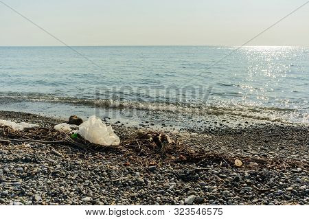 Trash And Junk On Dirty Pebble Beach Of Black Sea In Sochi Of Russia, Pollution Concept, Stock Photo