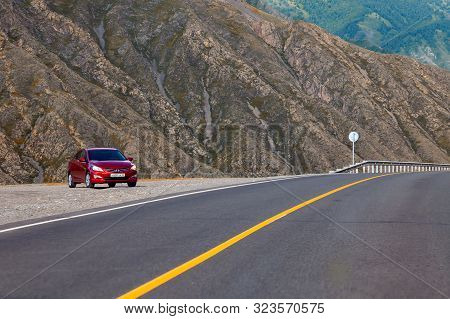Altai, Russia - 09.22.2019: Sedan Car Hyundai Solaris In Red Color Stand On Parking Near Asphalt Roa