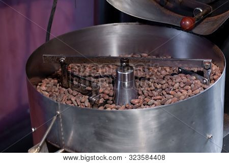 Worker Roasting Cocoa Beans In A Chocolate Making Factory.