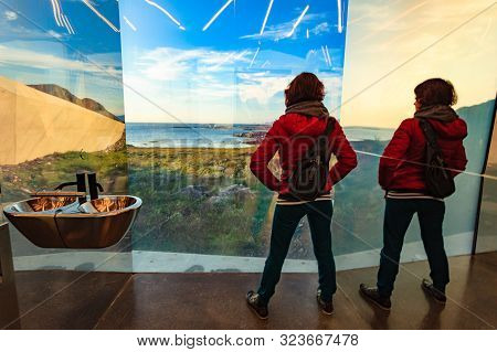 Tourist Woman Look Out At The Sea Coast Landscape From The Inside Of Mirrored Toilet Bukkekjerka Res