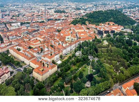 Aerial View Of Center City Graz From Helicopter Drone With Hill Schloßberg, Tower Uhrturm And Centra