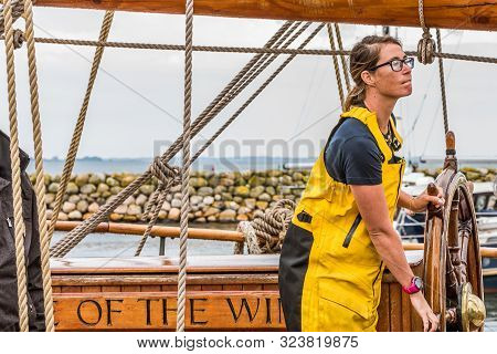 The First Mate At The Steering Wheel On The English Training Ship The Eye Of The Wind At The Quay In