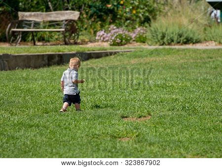 Davis, California, Usa. 9 June 2018. Candid Shot Of Unidentified Child Running Free On Loan At Davis