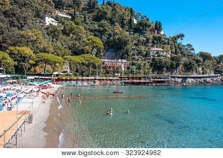 The Sand Beach Known As Paraggi Near Portofino In Genoa On A Blue Sky And Sea Background