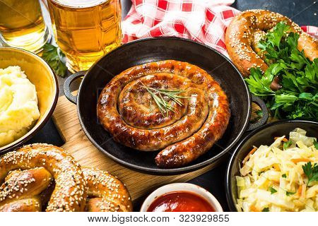 Oktoberfest Food. Sauerkraut, Sausage, Pretzel, Mashed Potato And Beer.