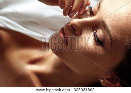 Beauty Model With Perfect Fresh Skin And Long Eyelashes. Youth And Skin Care Concept. Spa And Wellne