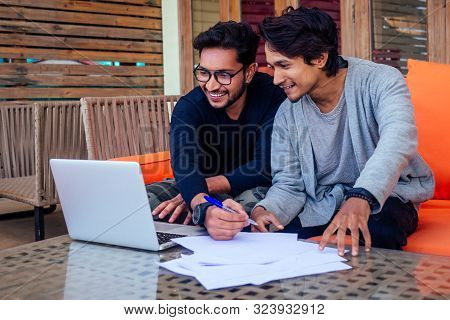 Indian Young Business People Businessman Freelancer Working Outdoors Chaise Lounge On The Beach With