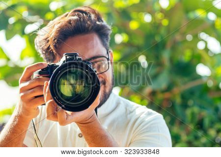 Handsome And Confident Indian Man Photographer With A Large Professional Camera Taking Pictures Phot