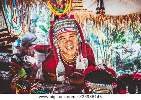 CHIANG MAI THAILAND- FEBRUARY, 2019 : Akha woman selling her goods in Baan Tong Luang eco village near Chiangmai,Thailand. Akha people arrived to Thailand from Myanmar 
