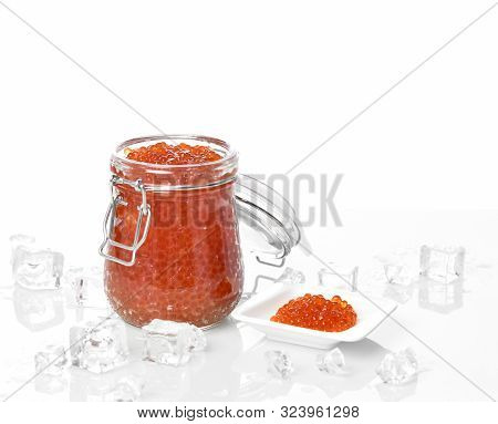 Salmon Keta Red Fish Caviar In Jar Can Composition And Little Plate With Ice On Table. Sea Food. Hea