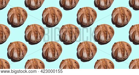 Fresh Homemade Rustic Rye Round Bread Seamless Pattern Isolated On Blue Background, Top View. Can Be