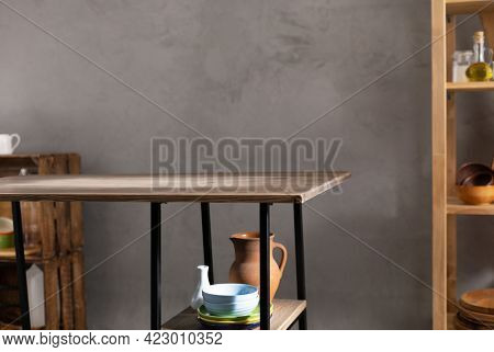 Kitchen room and empty crockery or ceramic dishes set. Clay dishware and tableware with wooden table near  wall background texture