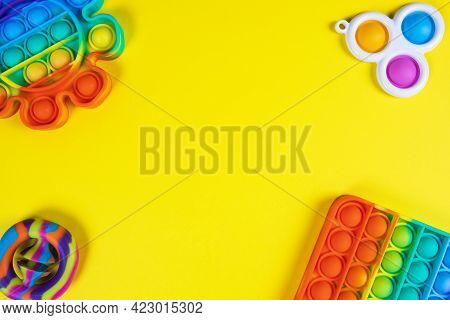 Anti-stress Toys Pop It, Simple Dimple, Snapperz On Yellow Background, Copy Space. Concept Trendy En