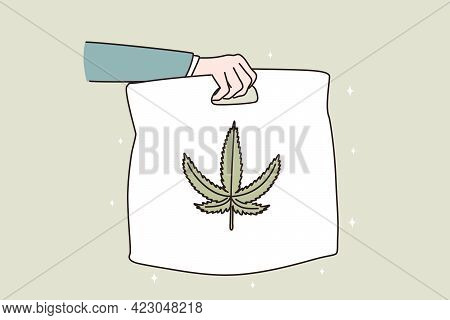 Marijuana Delivery And Distribution Concept. Hand Of Courier Holding Package With Cannabis With Leaf