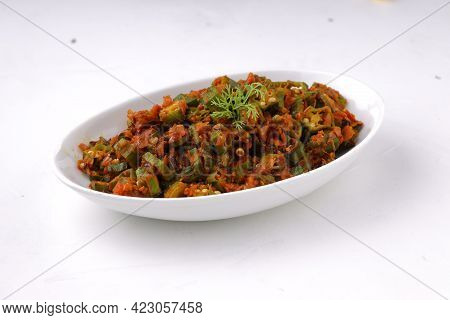 Okra Or Lady's Finger Masala Arranged In A White Ceramic Serving Bowl With White Background