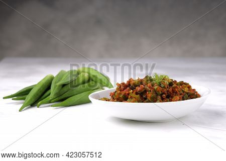 Okra Or Lady's Finger  Masala Arranged In A White Serving Bowl With White Background