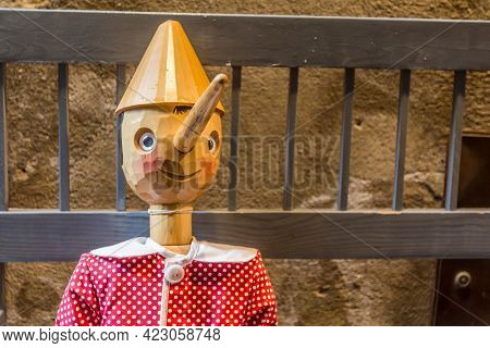 Orvieto, Italy, April 2019: Wooden Statue Of Pinocchio With Donkey Ears And Long Nose. Pinocchio Is 