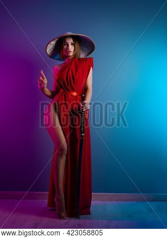 Sexy Woman In A Red Cape And An Asian Hat With A Katana In Her Hand Image Of A Samurai In Neon Color