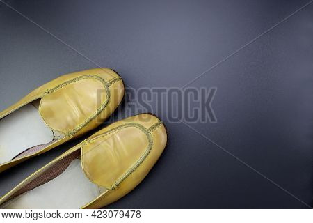 Women's Patent Leather Shoes. Yellow Loafers On A Gray Background.