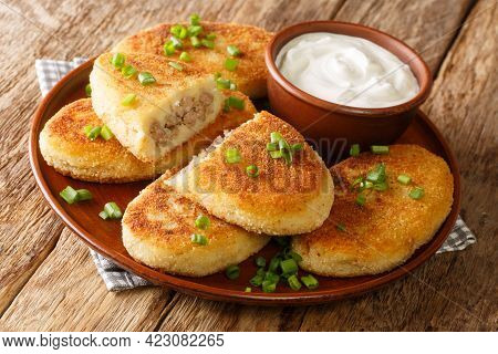 Homemade Hot Potato Zrazy Pies With Meat Filling With Sour Cream Close-up In A Plate On The Table. H