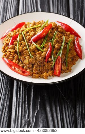 Khua Kling Is A Spicy, Dry Fried Curry From Thai Cuisine Closeup In The Plate On The Table. Vertical