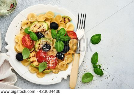 Pasta Fiocchi Salad With Vegetables Grilled Zucchini, Cherry Tomato, Olives, Basil And Parmesan Chee